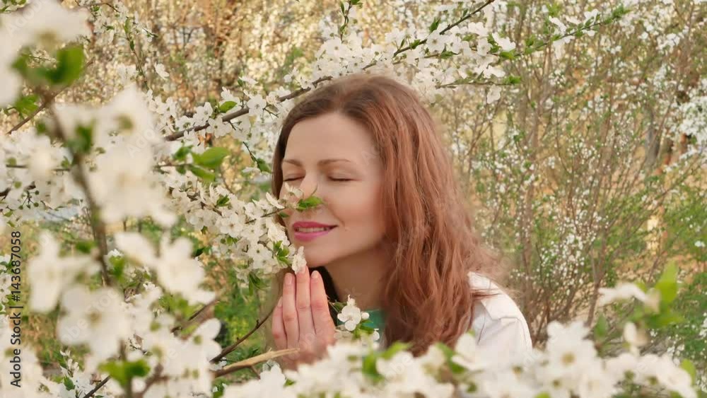 outdoor portrait of a beautiful woman in white jacket among white blossom tree outdoor portrait of a beautiful woman in white jacket among white blossom tree
