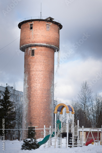 Old Water tower with icicles in winter photo