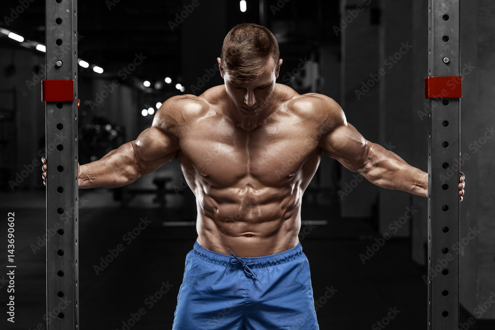 Sexy muscular man in gym, shaped abdominal. Strong male naked torso abs, working out Sexy muscular man in gym, shaped abdominal. Strong male naked torso abs, working out