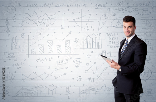 Salesman standing with drawn graph charts