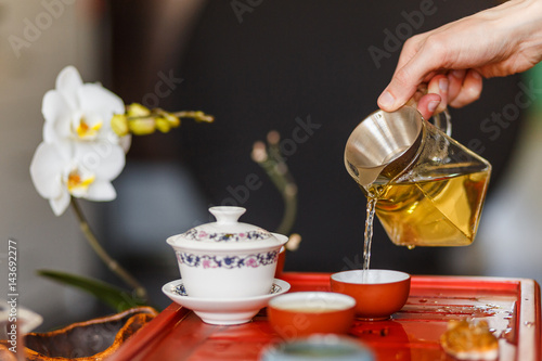 The tea ceremony. The hands of man pouring tea.