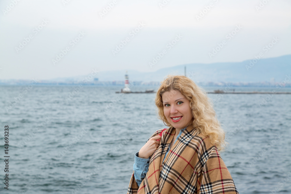 Blonde woman during fall time near coast Blonde woman during fall time near coast