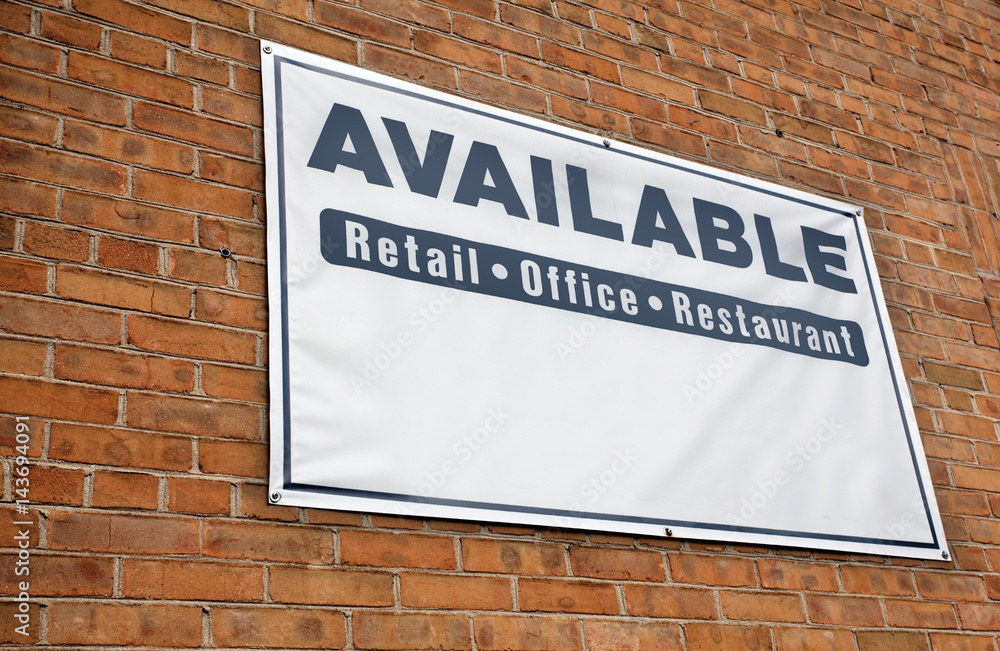 Obraz premium Real estate office space AVAILABLE sign on wall of brick building.