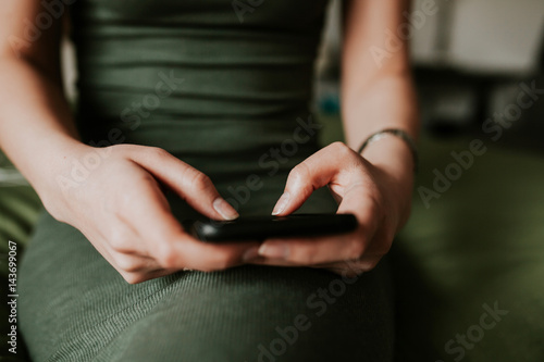 Woman using mobile smartphone. Modern or artistic concept. Close-up vintage smartphone approach.