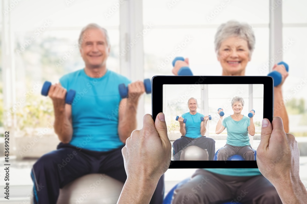 Composite image of cropped hand holding digital tablet Composite image of cropped hand holding digital tablet