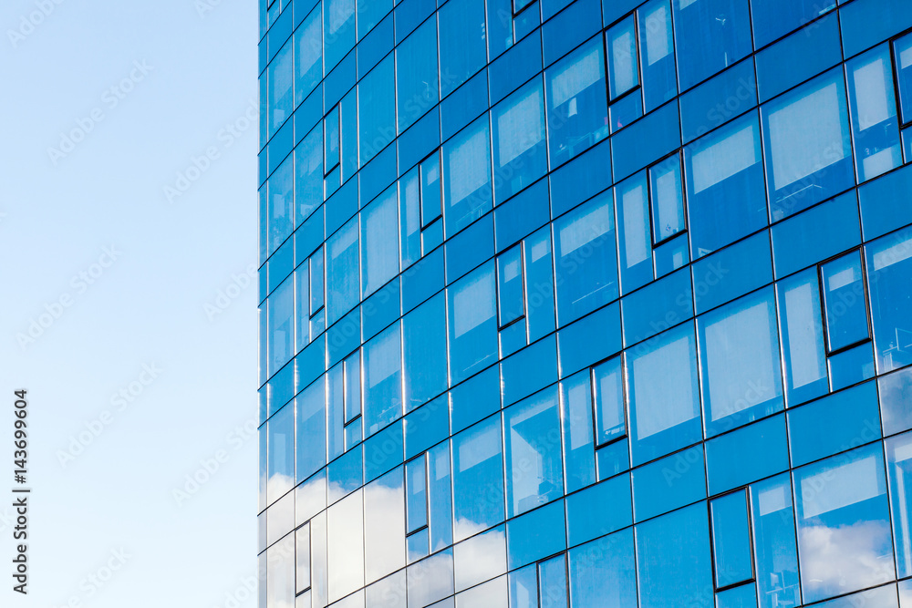 Facade glass building background on a blue sky. Concept for financial, economic, companies. Modern building, with structural lines meeting the sky.