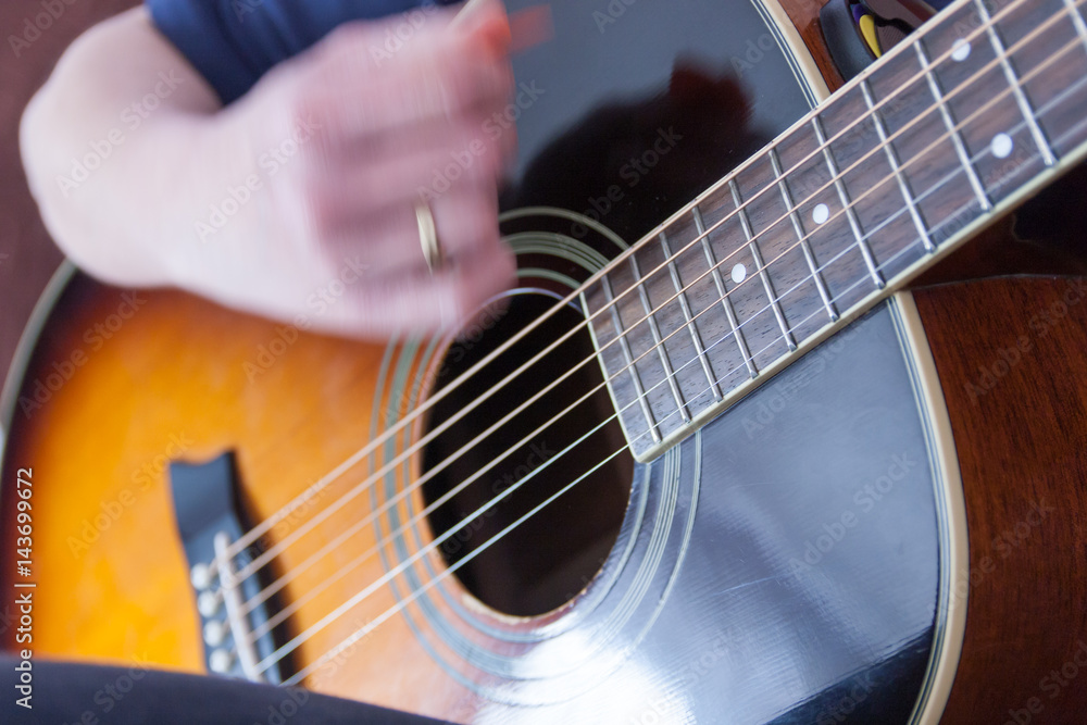 Fototapeta premium hand playing on an acoustic guitar