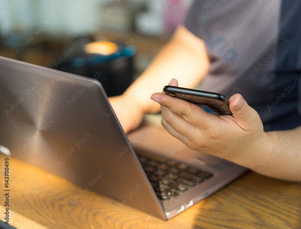 Woman hands work on labtop and smart phone. Woman hands work on labtop and smart phone.