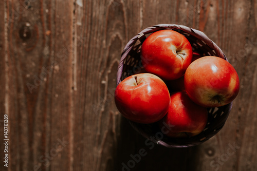 Bio apples on vintage wooden background. Fresh red apples. Top view.