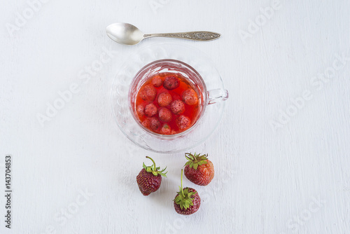 cup of strawberries compote top view on white background