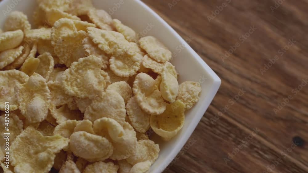 Corn flakes in white bowl with copyspace to the right. Slide right Corn flakes in white bowl with copyspace to the right. Slide right