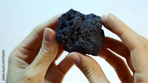 Manganese ore - Manganese (Mn). Mining and Extraction of minerals. Hand Holding Piece of black Manganese ore. Heavy industry