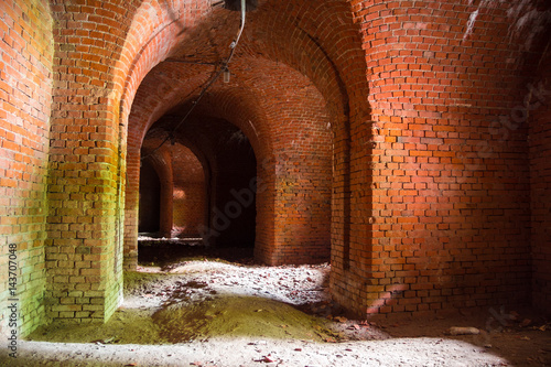 Corridors of the old fortification structure of red brick © Mulderphoto