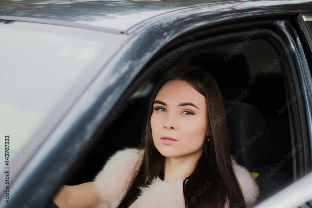 Portrait of a very beautiful girl in a forest dressed in fur in a car Portrait of a very beautiful girl in a forest dressed in fur in a car