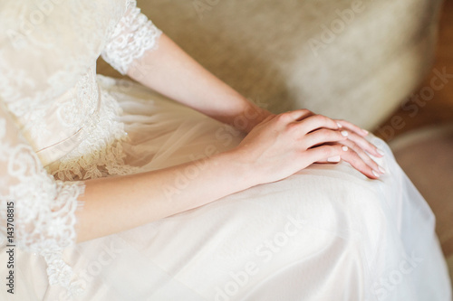 hands of the elegant bride in a wedding lacy dress. morning gatherings of bride. tenderness concept.