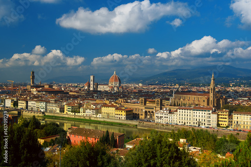 View of the beautiful medieval italian city and culture capital - Florence with cathedrals and bridges over river and blue cloudy sky. Travel outdoor sightseeing historical background.