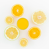 Citrus fruits and juice made of lemon, orange, sweetie isolated on white background. Flat lay, top view. Summer background
