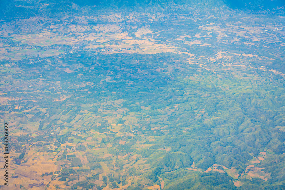 Mountains under clouds. View from the airplane . Mountains under clouds. View from the airplane .
