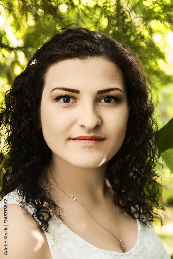 Portrait of a beautiful brunette in a park among the leaves Portrait of a beautiful brunette in a park among the leaves