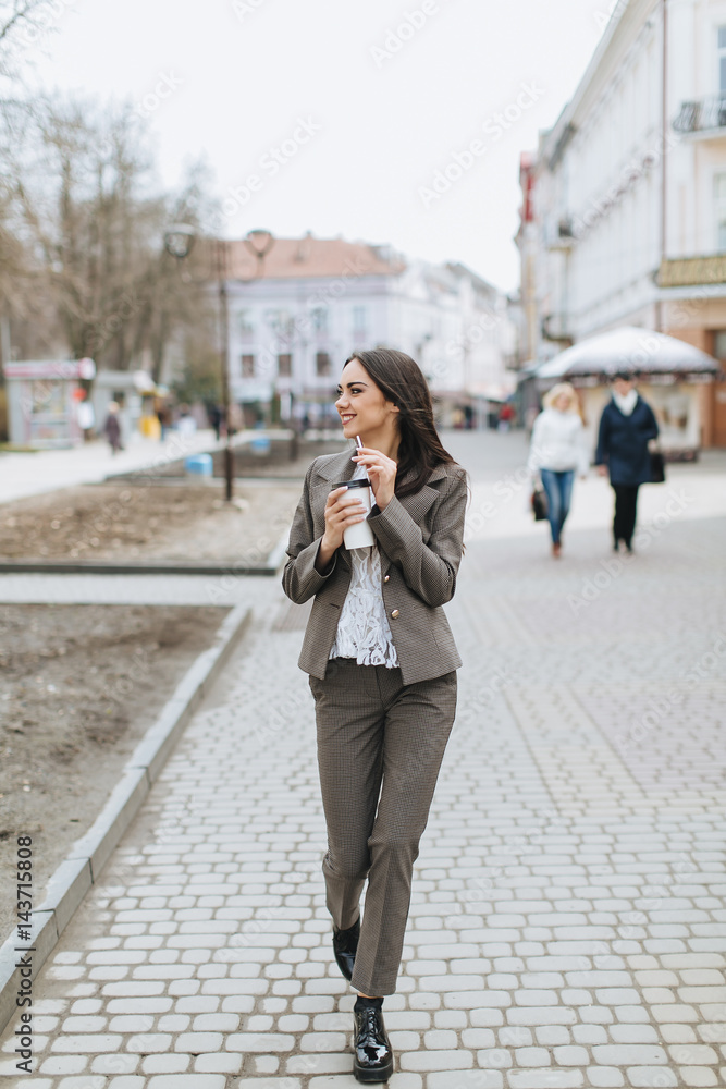 Business women walking on the street and drinking coffee. Business women walking on the street and drinking coffee.