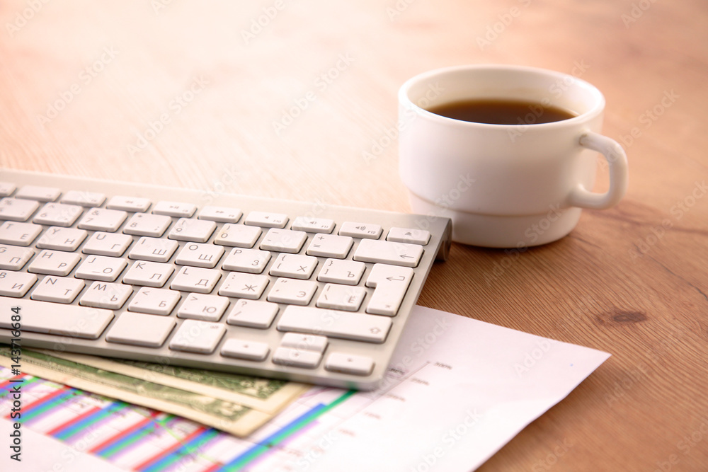 on the desktop computer and a cup of coffee on the desktop computer and a cup of coffee