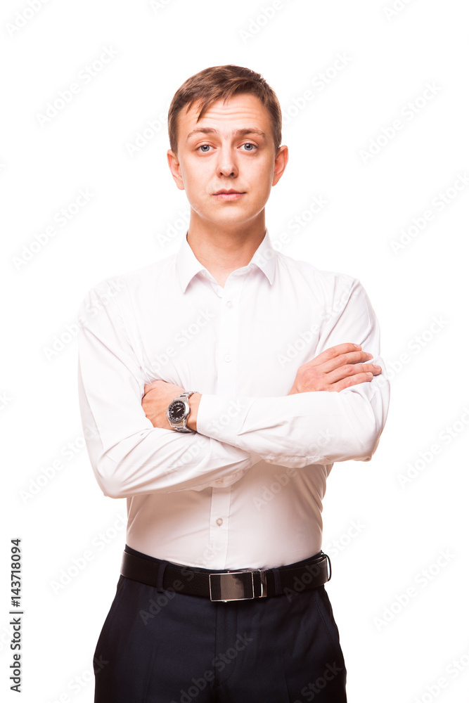 Young handsome businessman in white shirt is standing straight and crossing his hands, portrait isolated on white background