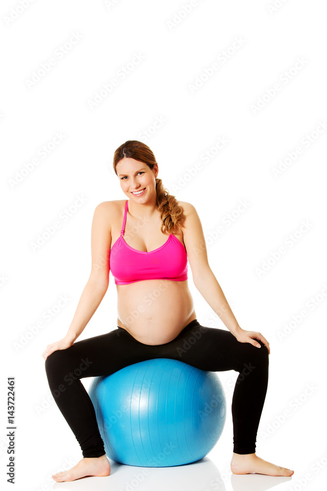 Young pregnant woman excercises with gymnastic ball Young pregnant woman excercises with gymnastic ball