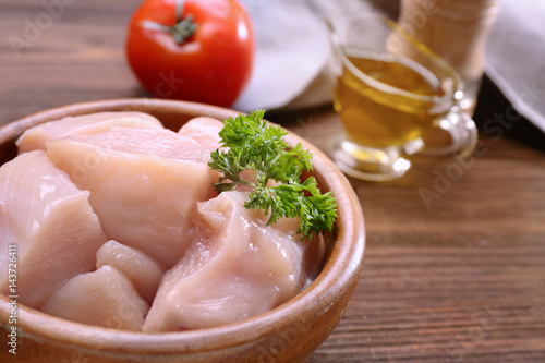 Raw chicken meat on wooden background