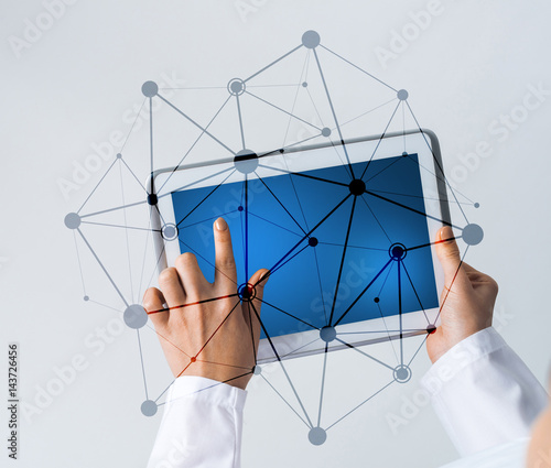 Close of female doctor hands working with tablet pc computer