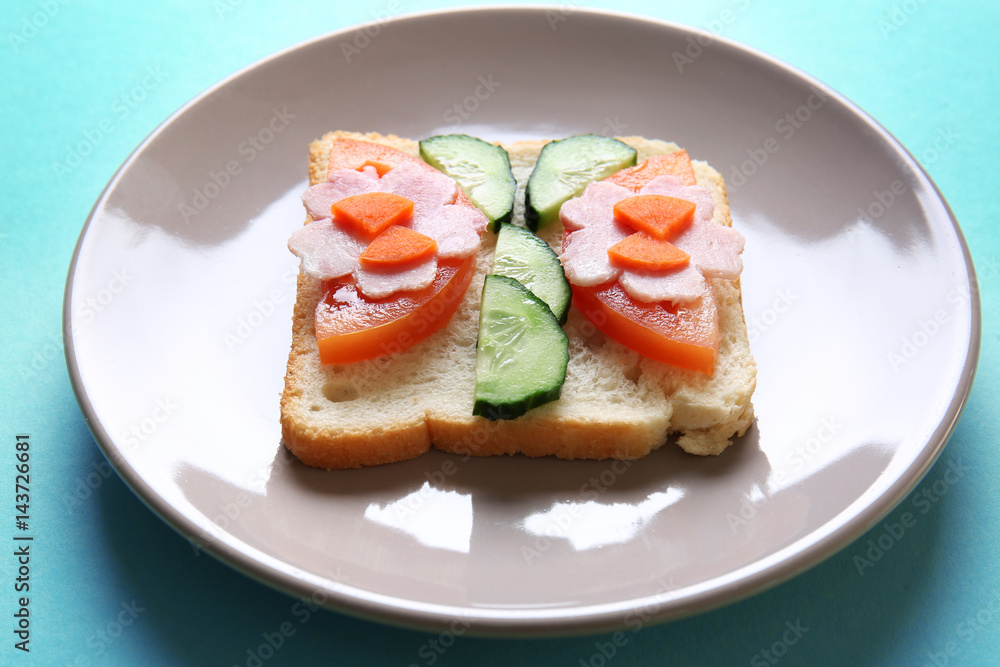 Plate with funny sandwich on color background Plate with funny sandwich on color background