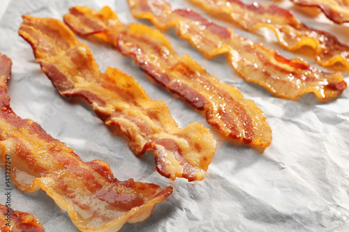 Parchment with strips of fried bacon, closeup