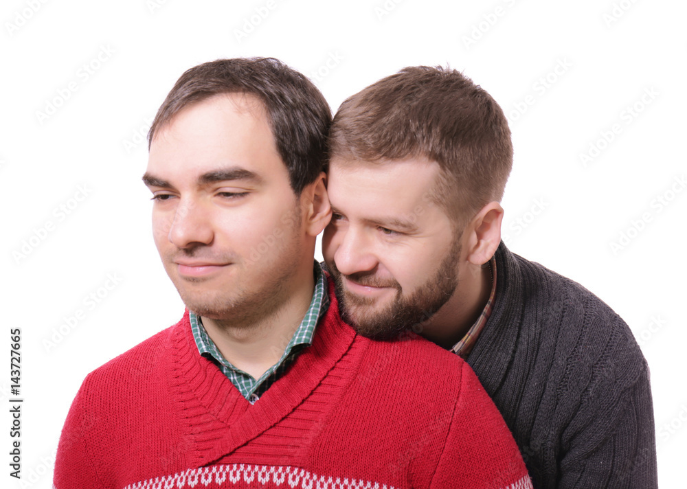 Happy gay couple posing on white background Happy gay couple posing on white background