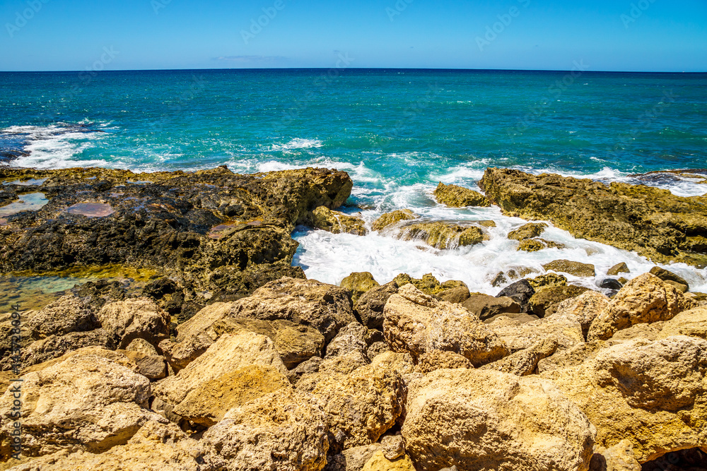 Waves of the Pacific Ocean crashing on the rocks on the shoreline of Ko Olina on the island of Oahu in the island state of Hawaii Waves of the Pacific Ocean crashing on the rocks on the shoreline of Ko Olina on the island of Oahu in the island state of Hawaii