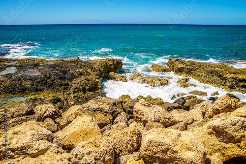 Waves of the Pacific Ocean crashing on the rocks on the shoreline of Ko Olina on the island of Oahu in the island state of Hawaii 