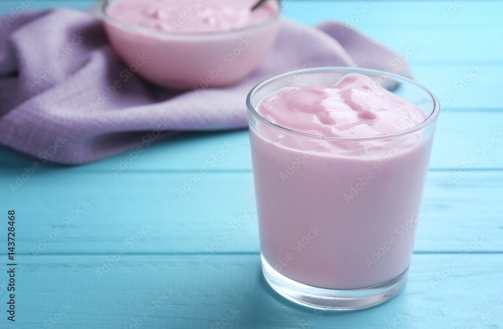 Tasty yogurt in glass on wooden table Tasty yogurt in glass on wooden table