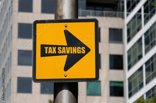 Directional sign with conceptual message TAX SAVINGS