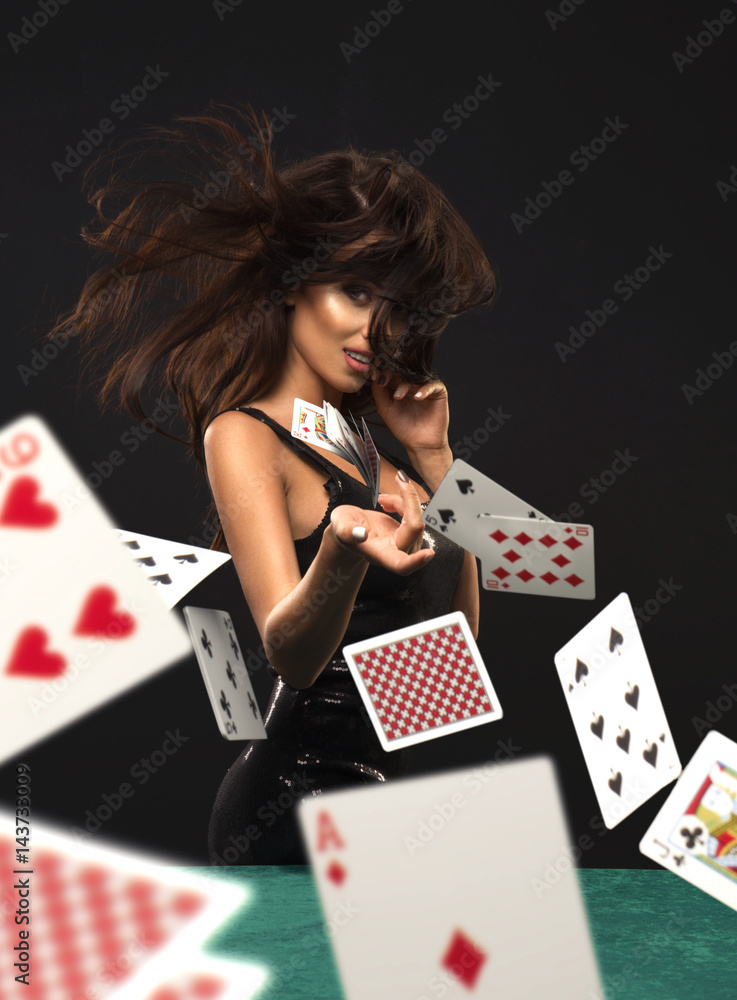 Sexy brunette woman with poker cards on black background foto de Stock |  Adobe Stock