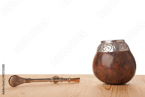 Yerba mate-South American tea  in traditional calabash with bombilla isolated on white background photo