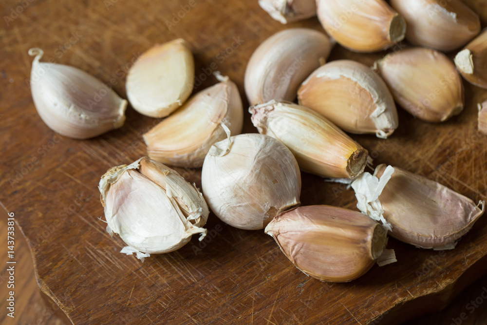 Garlic and garlic press on rustic wooden wooden background Garlic and garlic press on rustic wooden wooden background
