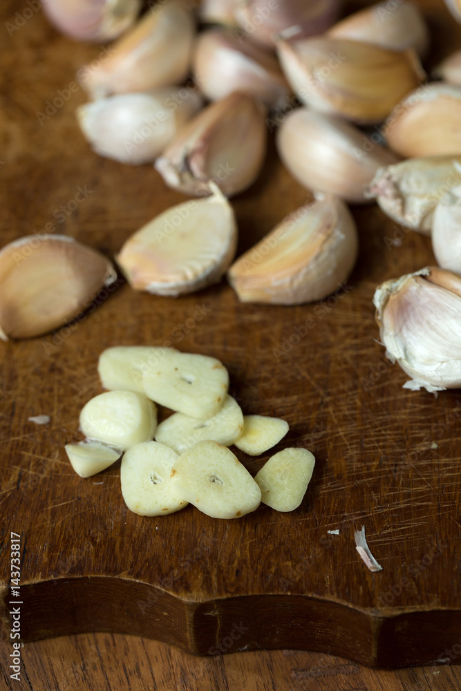 Garlic and garlic press on rustic wooden wooden background Garlic and garlic press on rustic wooden wooden background