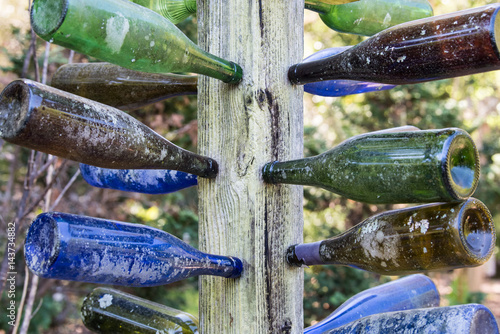 glass bottles mounted on tree or post