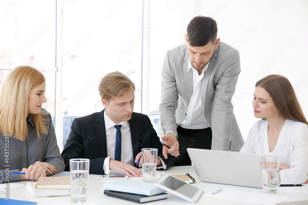 Business trainer giving presentation to group of people Business trainer giving presentation to group of people