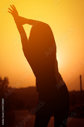 Woman exercising outdoor at sunset