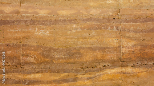 Fotografie Grunge orange red wall or stone earthen wall in natural texture pattern backgrou