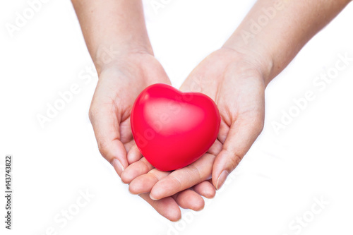 hand holding a red heart on white background