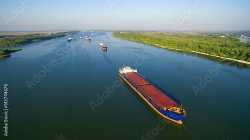 Slika na platnu Caravan of barges on the river