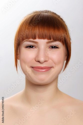 close-up studio portrait of a young beautiful woman demonstratin