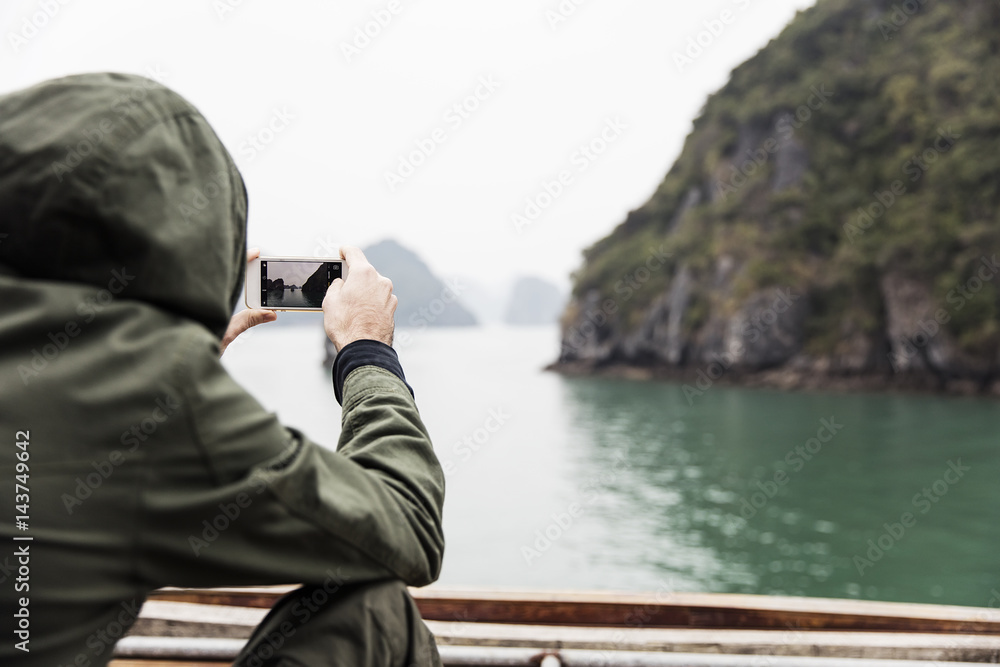 Obraz premium Man photographed from the boat in Ha Long Bay in Vietnam