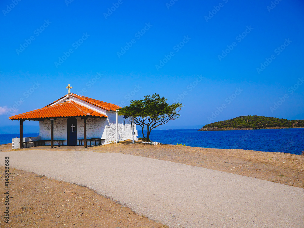 Traditional small white church with sea view in Cassandra peninsula,Greece.