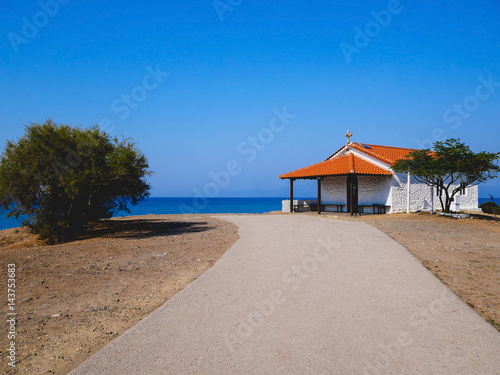 Traditional small white church with sea view in Cassandra peninsula Greece.